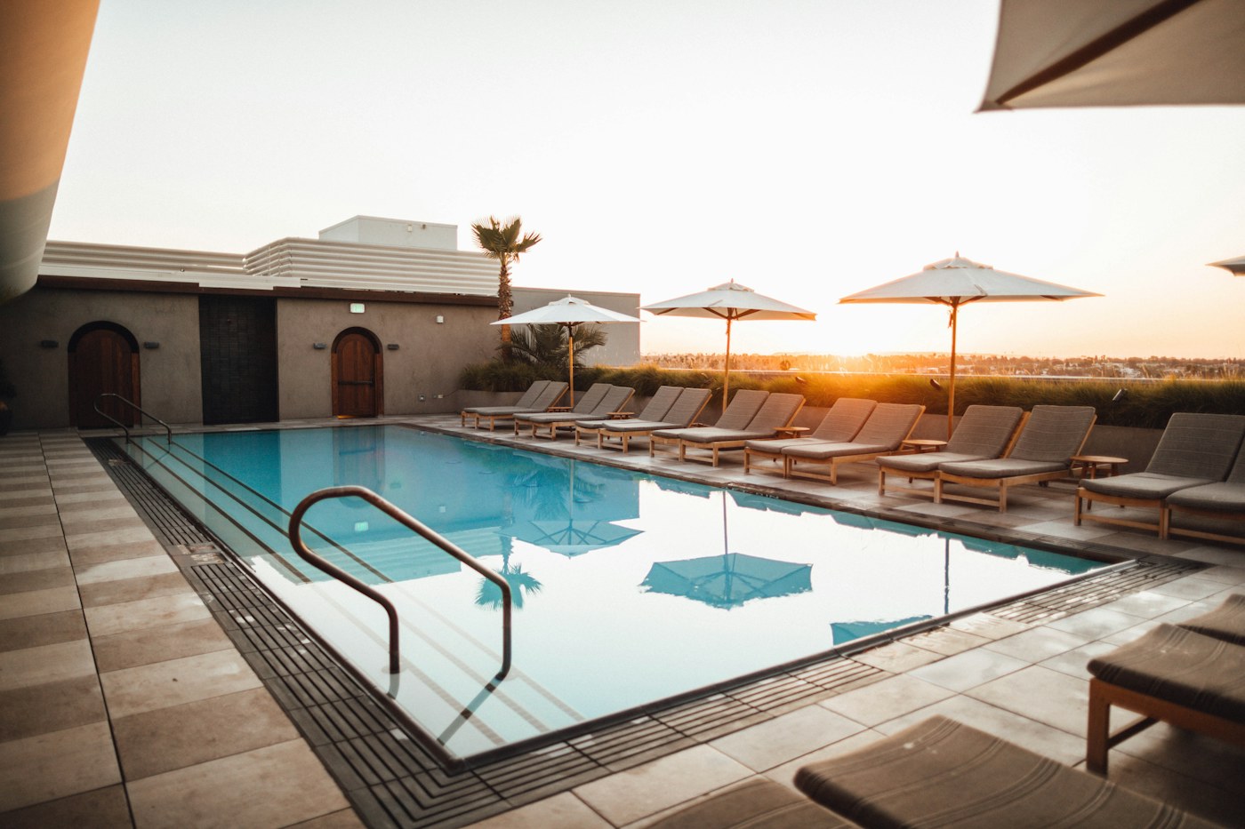 Sunlit turquoise backyard swimming pool